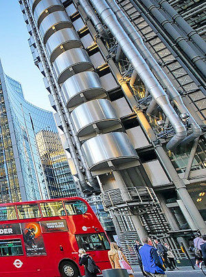 Lloyds insurance building with a red London bus passing by