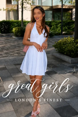 Slender woman in a short white dress showing off her sexy legs